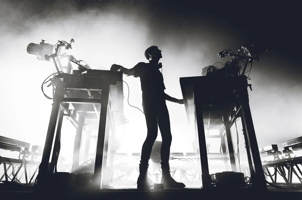 Richie Hawtin performing his CLOSE live show behind layered visuals